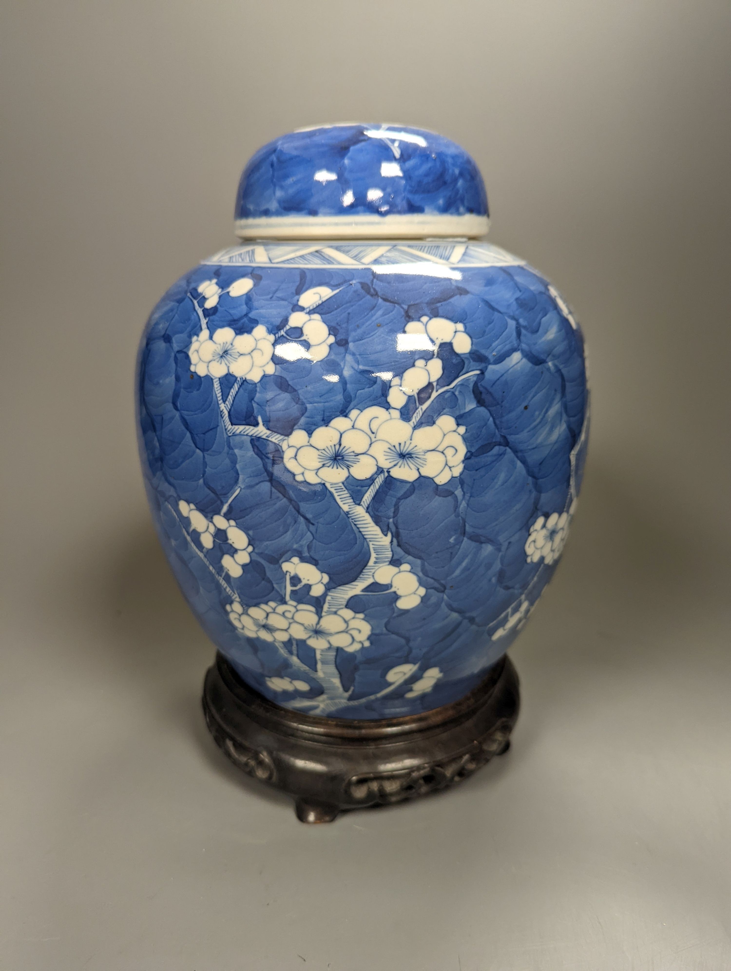 A 19th century Chinese prunus blossom ginger jar and cover, on stand, height 25cm